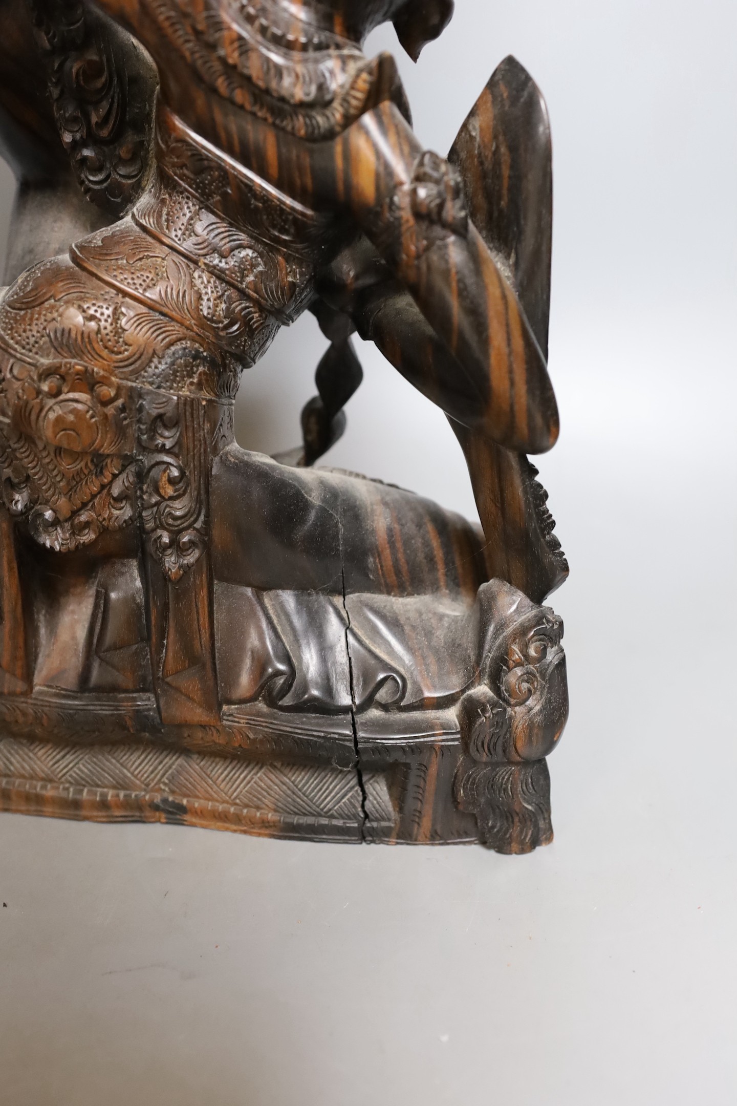 A Balinese carved coromandel deity group , 50 cms high.